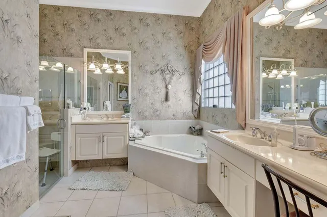 a bathroom with a granite countertop sink mirror bathtub and shower