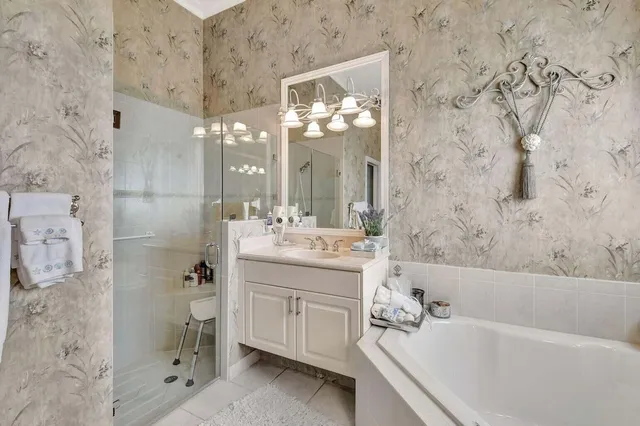 a bathroom with a bathtub sink vanity granite and a toilet