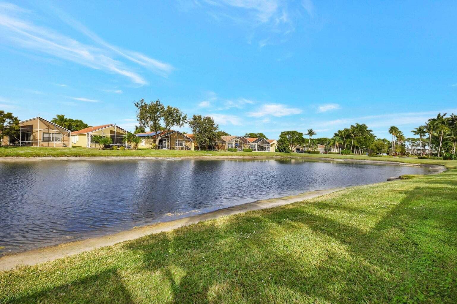 7035 Vivaldi Lane Delray Beach, FL 33446 - Photo 23 of 39 a view of a lake with houses in the back