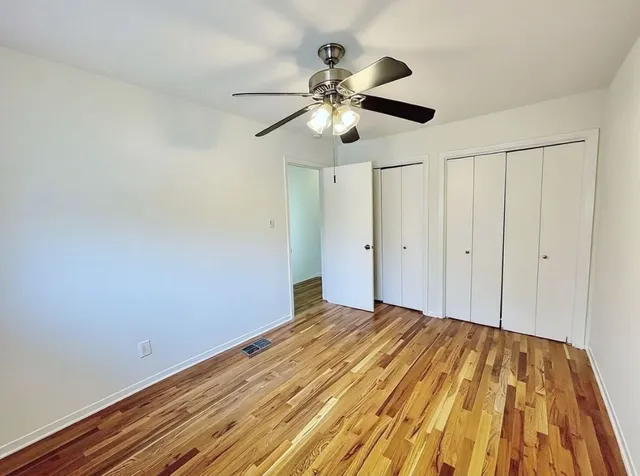 a view of a room with wooden floor
