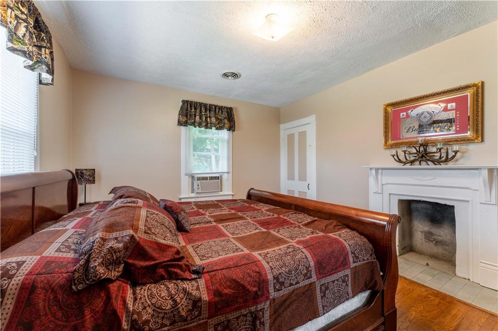 402 Walnut Street Point Marion, PA 15474 - Photo 13 of 19 a bedroom with a bed and a fireplace