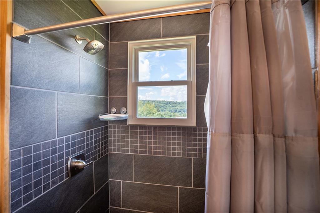 402 Walnut Street Point Marion, PA 15474 - Photo 16 of 19 a bathroom with a window and a shower
