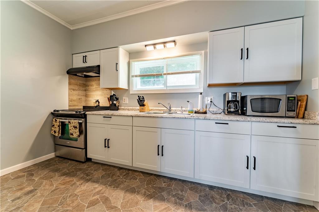 402 Walnut Street Point Marion, PA 15474 - Photo 7 of 19 a kitchen with cabinets appliances a sink and a window