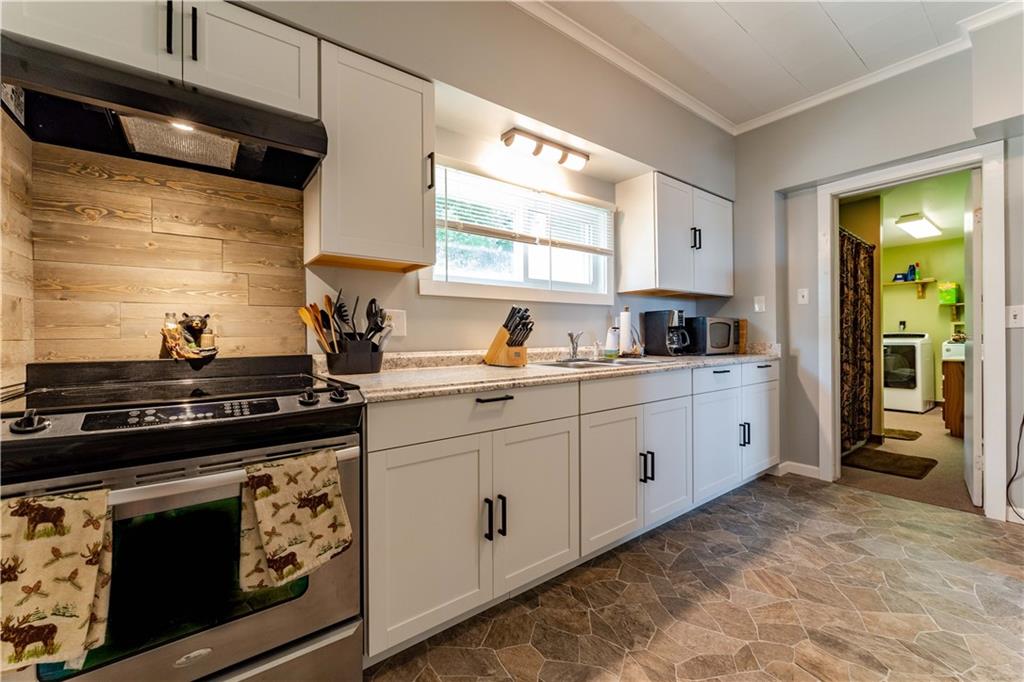 402 Walnut Street Point Marion, PA 15474 - Photo 8 of 19 a kitchen with white cabinets and appliances
