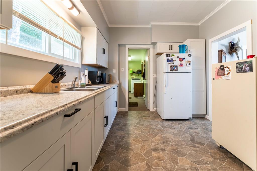 402 Walnut Street Point Marion, PA 15474 - Photo 9 of 19 a kitchen with a refrigerator and a sink