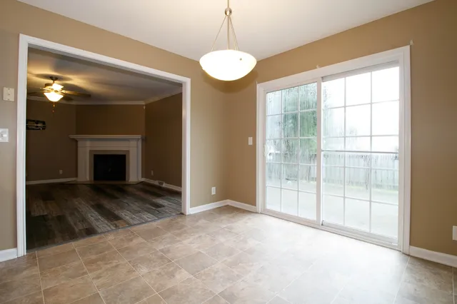 a view of empty room with window and fireplace