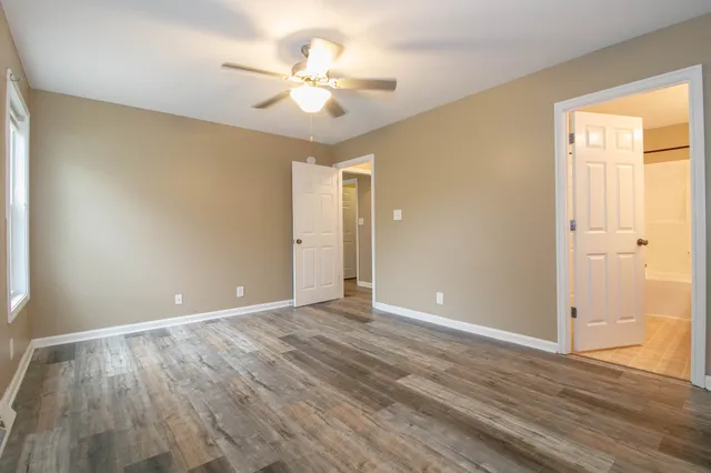 a view of an empty room with wooden floor