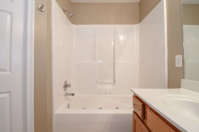 a bathroom with a bathtub and a sink