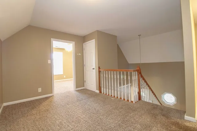 a view of a hallway with wooden floor and entryway