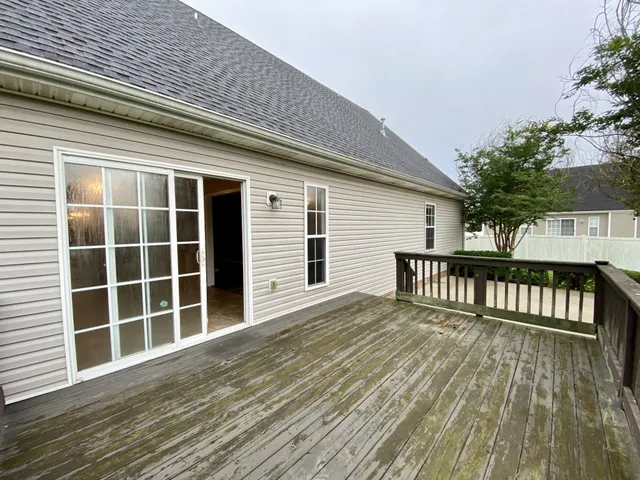a view of a house with wooden deck