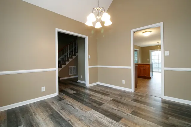 wooden floor in an empty room with a bathroom