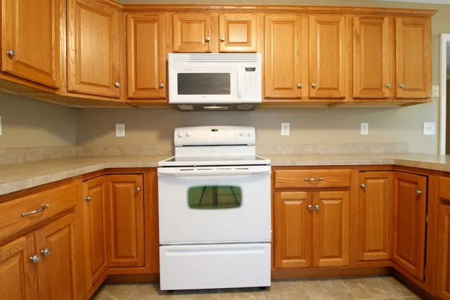 a kitchen with granite countertop cabinets stainless steel appliances and sink