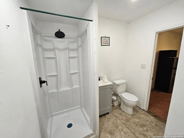 a bathroom with a toilet and a shower