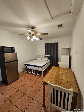 a living room with a bed and a chandelier
