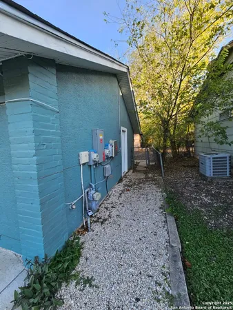 a backyard of a house with table and chairs