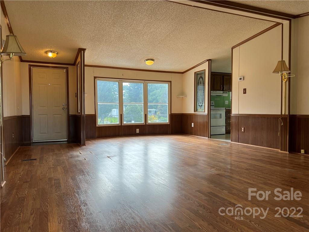 8581 Highway 268 Elkin, NC 28621 - Photo 11 of 45 a view of an empty room with wooden floor and a window