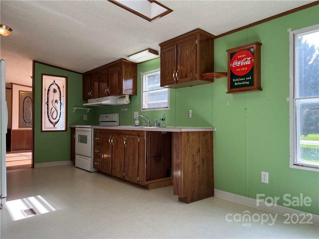 8581 Highway 268 Elkin, NC 28621 - Photo 13 of 45 a kitchen with cabinets and a wooden floor