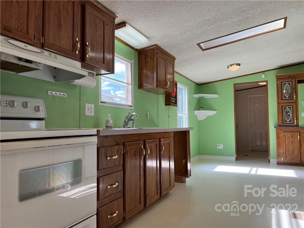 8581 Highway 268 Elkin, NC 28621 - Photo 17 of 45 a kitchen with cabinets and stainless steel appliances