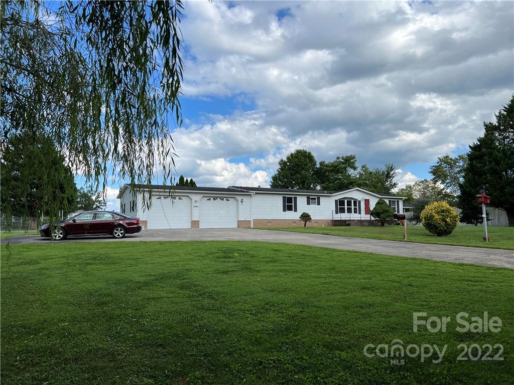 8581 Highway 268 Elkin, NC 28621 - Photo 2 of 45 a view of a big house with a big yard and large trees