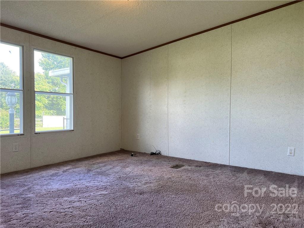 8581 Highway 268 Elkin, NC 28621 - Photo 23 of 45 an empty room with a empty space and windows
