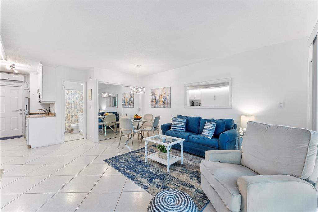 555 North Riverside Drive, Unit 25 Pompano Beach, FL 33062 - Photo 9 of 24 a living room with furniture and a table