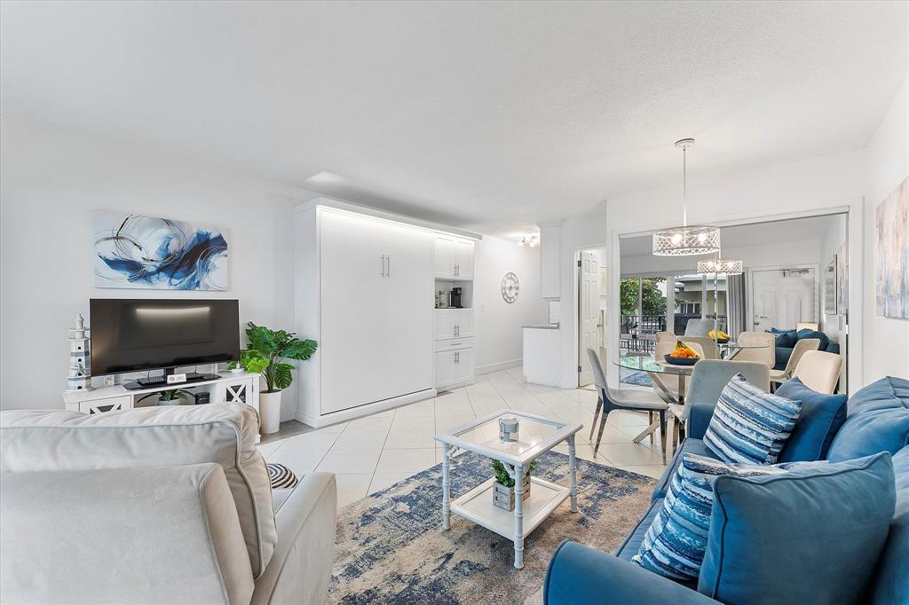 555 North Riverside Drive, Unit 25 Pompano Beach, FL 33062 - Photo 10 of 24 a living room with furniture and a flat screen tv