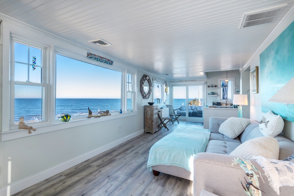 232 Manomet Point Road Plymouth, MA 02360 - Photo 1 of 24 a living room with furniture and a chandelier