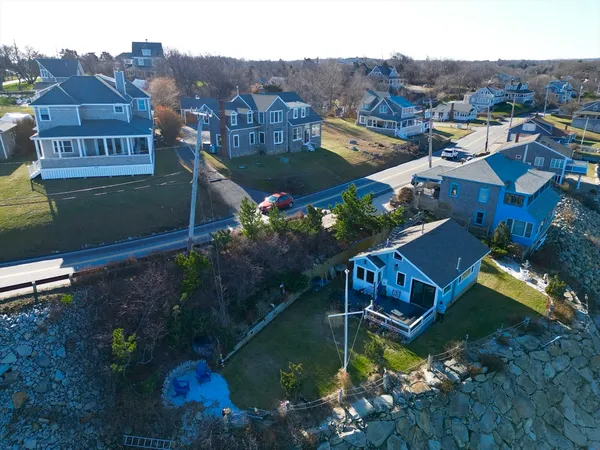 an aerial view of a house with a garden and lake view