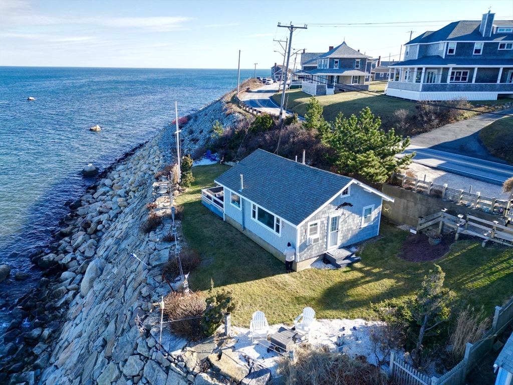 232 Manomet Point Road Plymouth, MA 02360 - Photo 2 of 24 a view of a city with lawn chairs and large trees