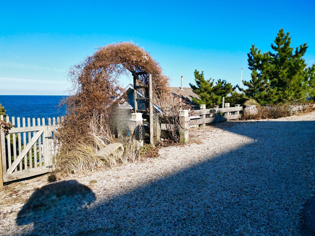 232 Manomet Point Road Plymouth, MA 02360 - Photo 24 of 24 a backyard of a house with table and chairs