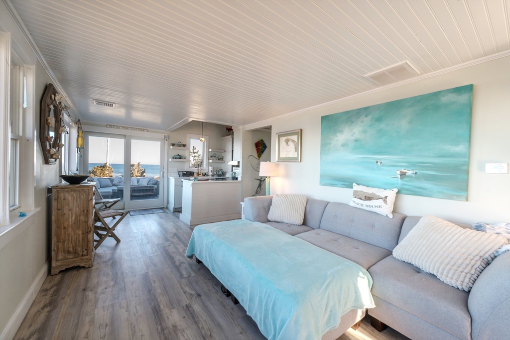 232 Manomet Point Road Plymouth, MA 02360 - Photo 3 of 24 a living room with furniture and a wooden floor