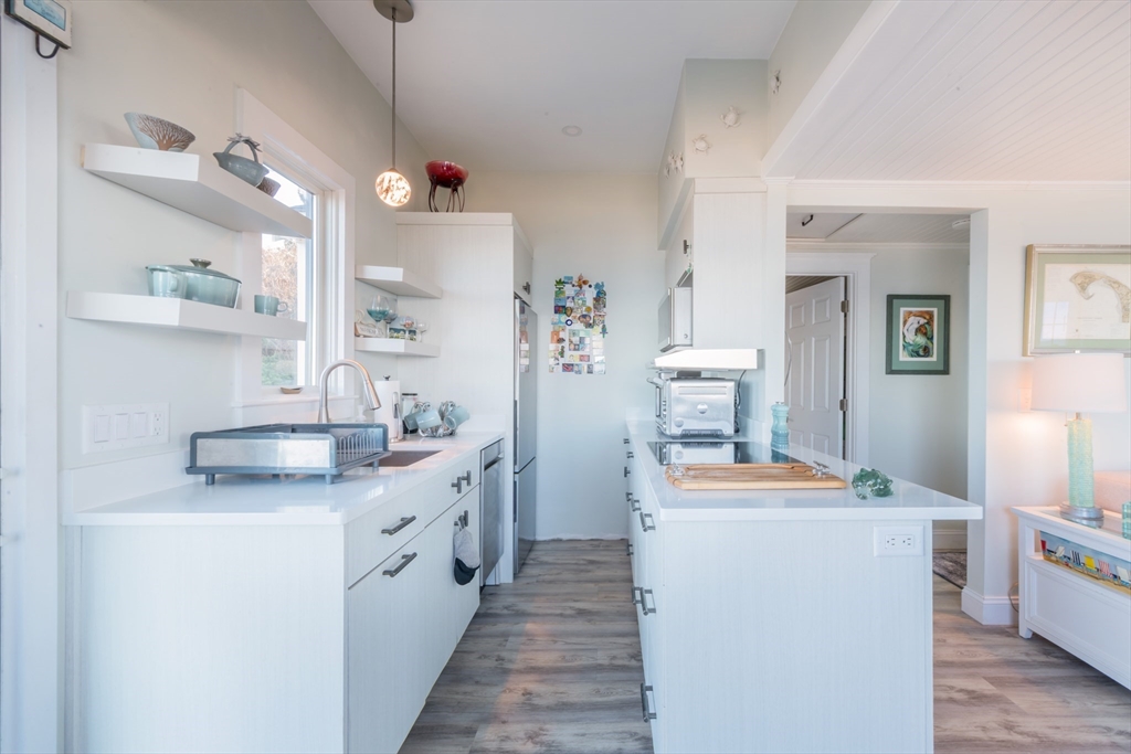 232 Manomet Point Road Plymouth, MA 02360 - Photo 5 of 24 a kitchen with a sink stove and refrigerator