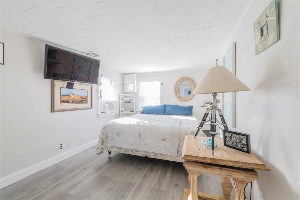 232 Manomet Point Road Plymouth, MA 02360 - Photo 9 of 24 a bedroom with a bed and a flat screen tv