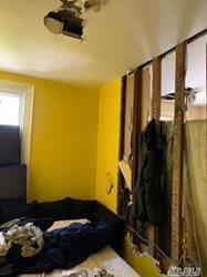 689 Madison Street Brooklyn, NY 11221 - Photo 12 of 20 a bed sitting in a bedroom next to a window