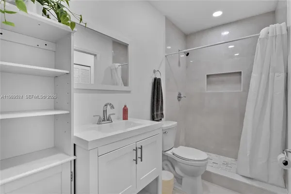 a bathroom with a sink toilet and shower