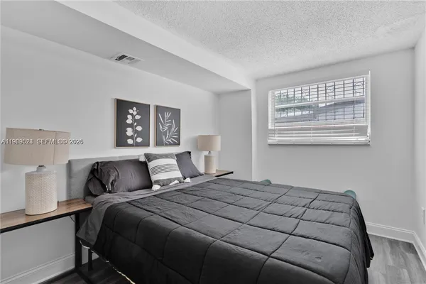 a bedroom with a bed and a night stand