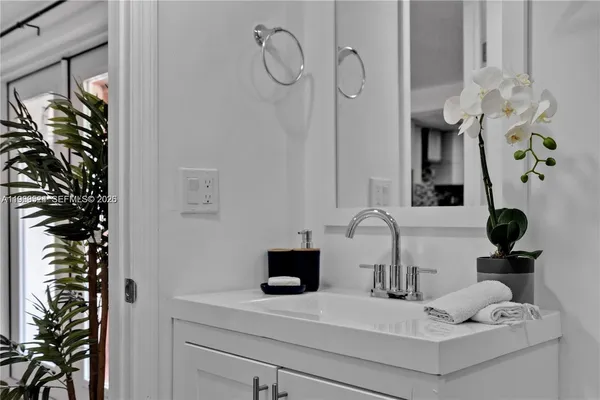 a bathroom with a sink mirror and vanity