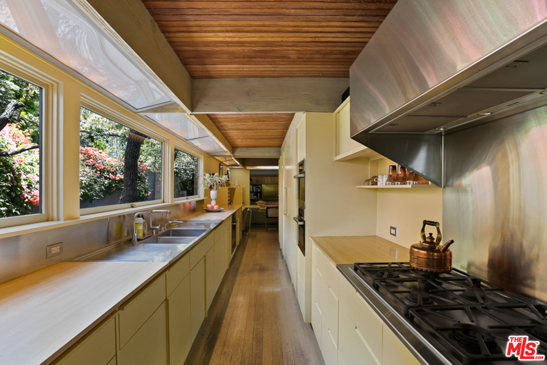 11600 Amanda Drive Studio City, CA 91604 - Photo 21 of 33 a kitchen with lots of counter top space and wooden floor