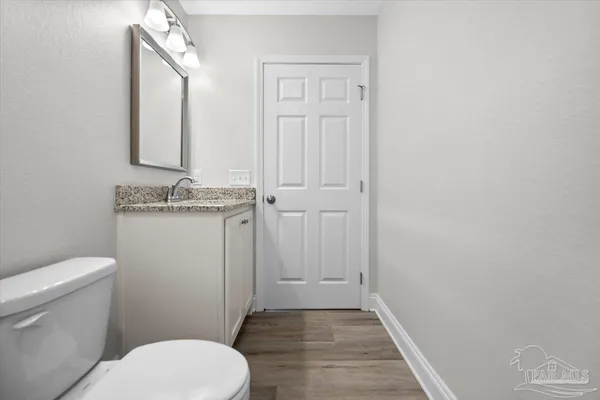 a bathroom with a granite countertop toilet a sink and a bathtub