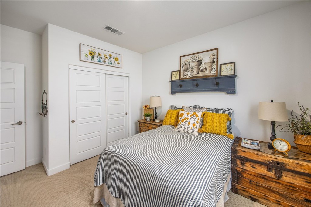 5806 Dragonfly Street Banning, CA 92220 - Photo 12 of 40 a bedroom with a bed and a lamp on dresser