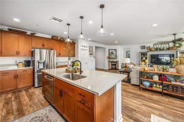 a kitchen with stainless steel appliances granite countertop a sink refrigerator and microwave