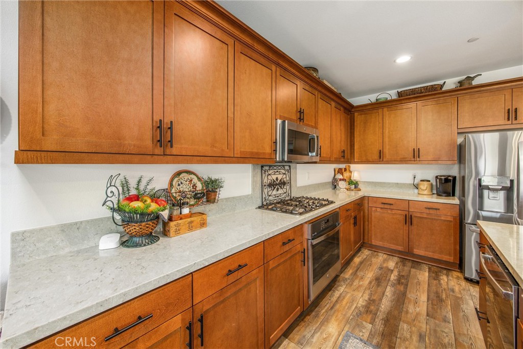 5806 Dragonfly Street Banning, CA 92220 - Photo 23 of 40 a kitchen with stainless steel appliances granite countertop a sink refrigerator and microwave