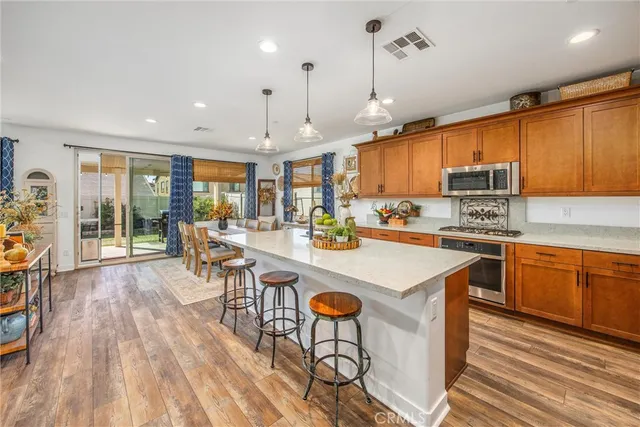 a living room with furniture and a view of kitchen