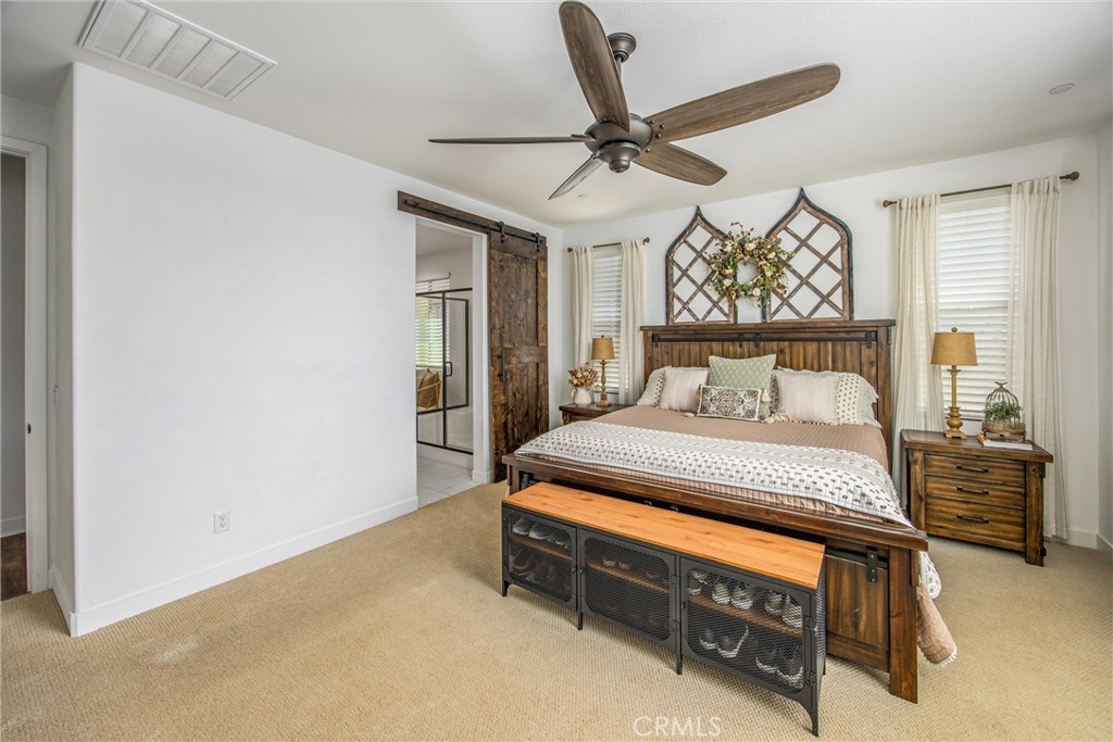 5806 Dragonfly Street Banning, CA 92220 - Photo 30 of 40 a bedroom with a bed and a chandelier