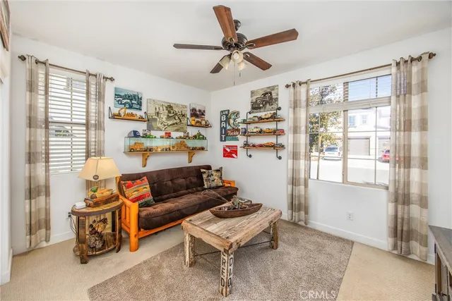 a living room with furniture and a ceiling fan