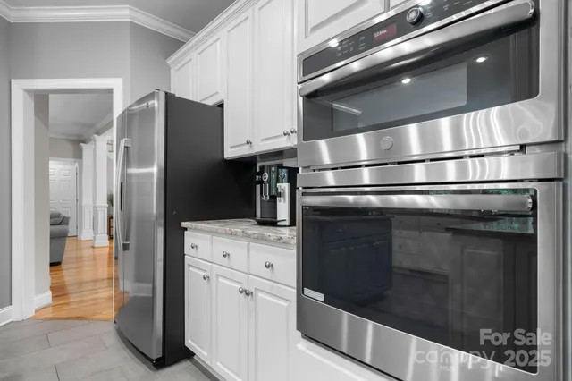 a refrigerator freezer sitting inside of a kitchen