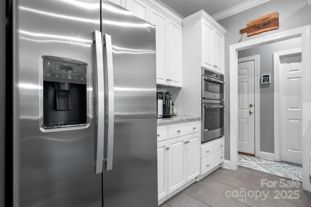 a kitchen with cabinets and stainless steel appliances