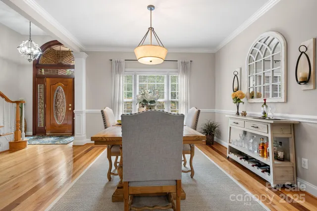 a dining room with furniture window and wooden floor