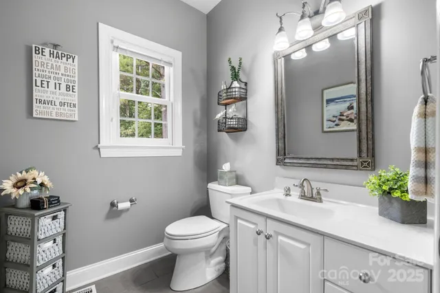 a bathroom with a toilet a sink and mirror