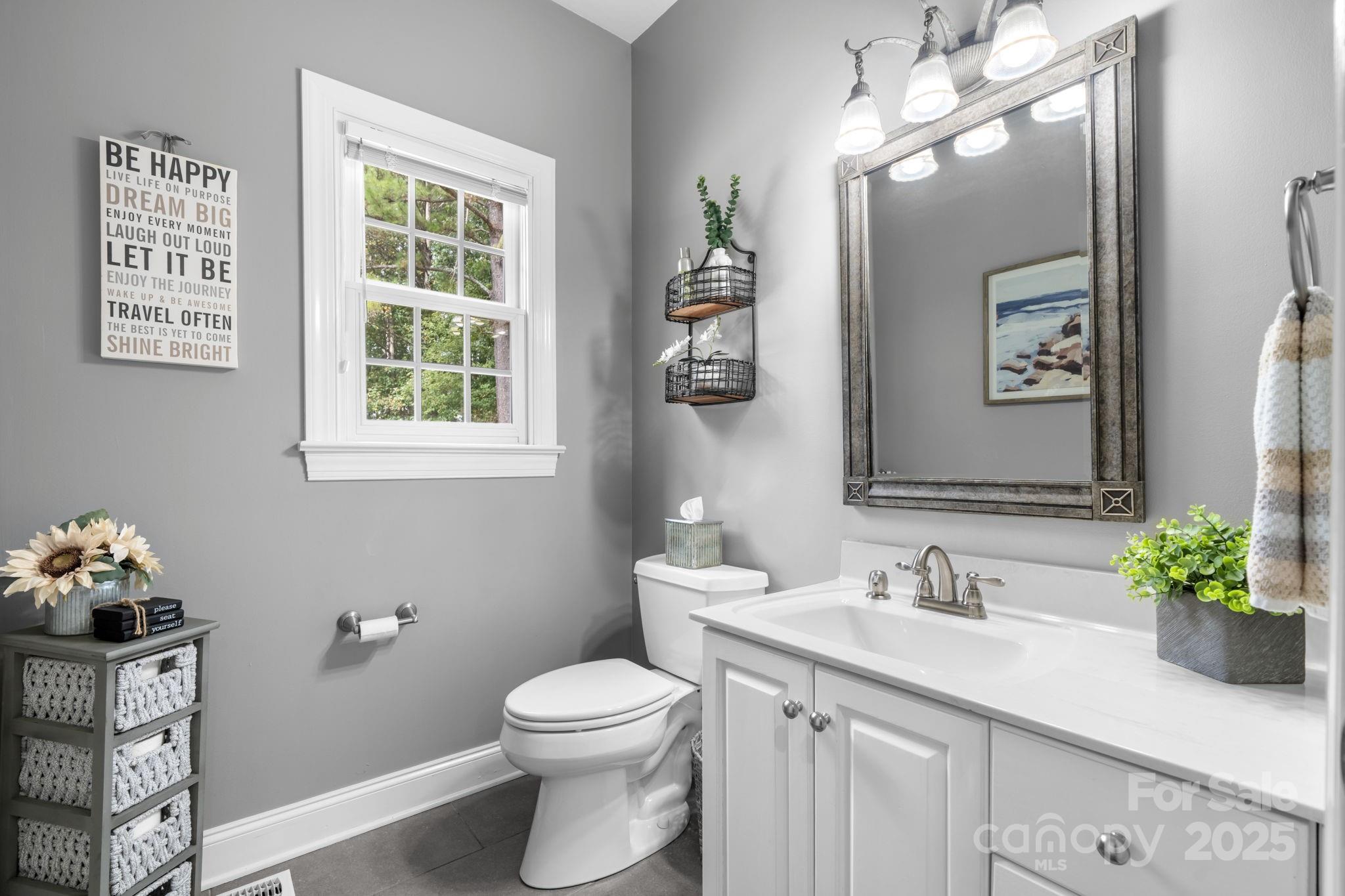 104 Blackhawk Ridge Court Granite Falls, NC 28630 - Photo 19 of 48 a bathroom with a toilet a sink and mirror